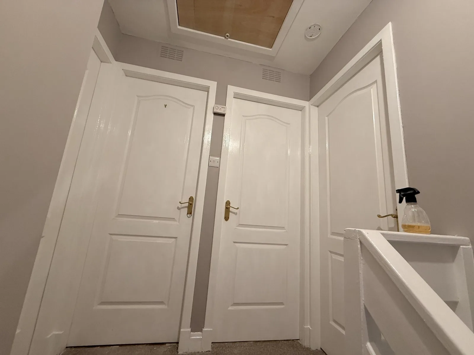 Landing with doors, frames and banister glossed white and walls painted grey by LJAY’s