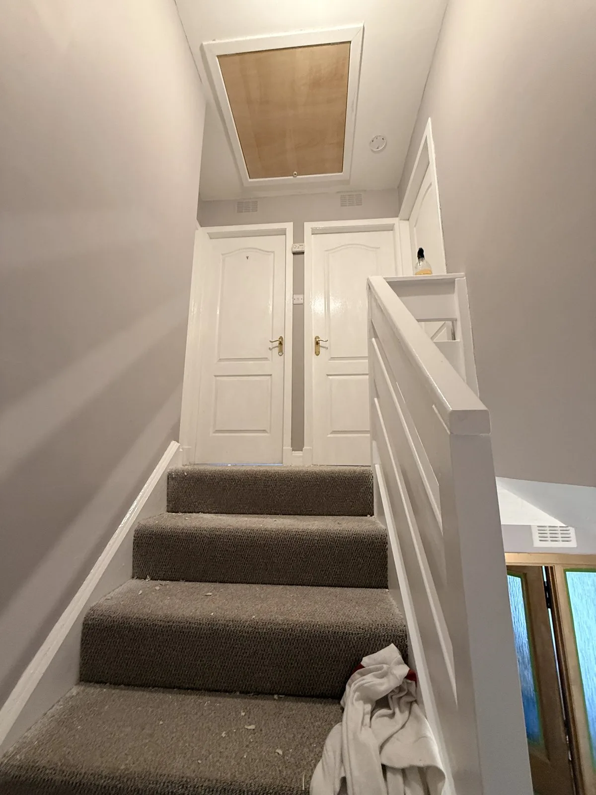 Stairwell and landing walls painted with white glossed spindles by LJAY’s decorators